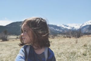 Cute toddler in front of mountains