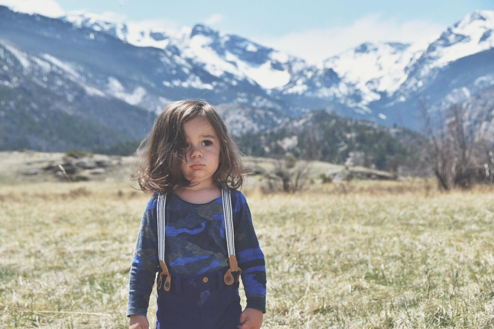 Cute fashion toddler in front of mountains
